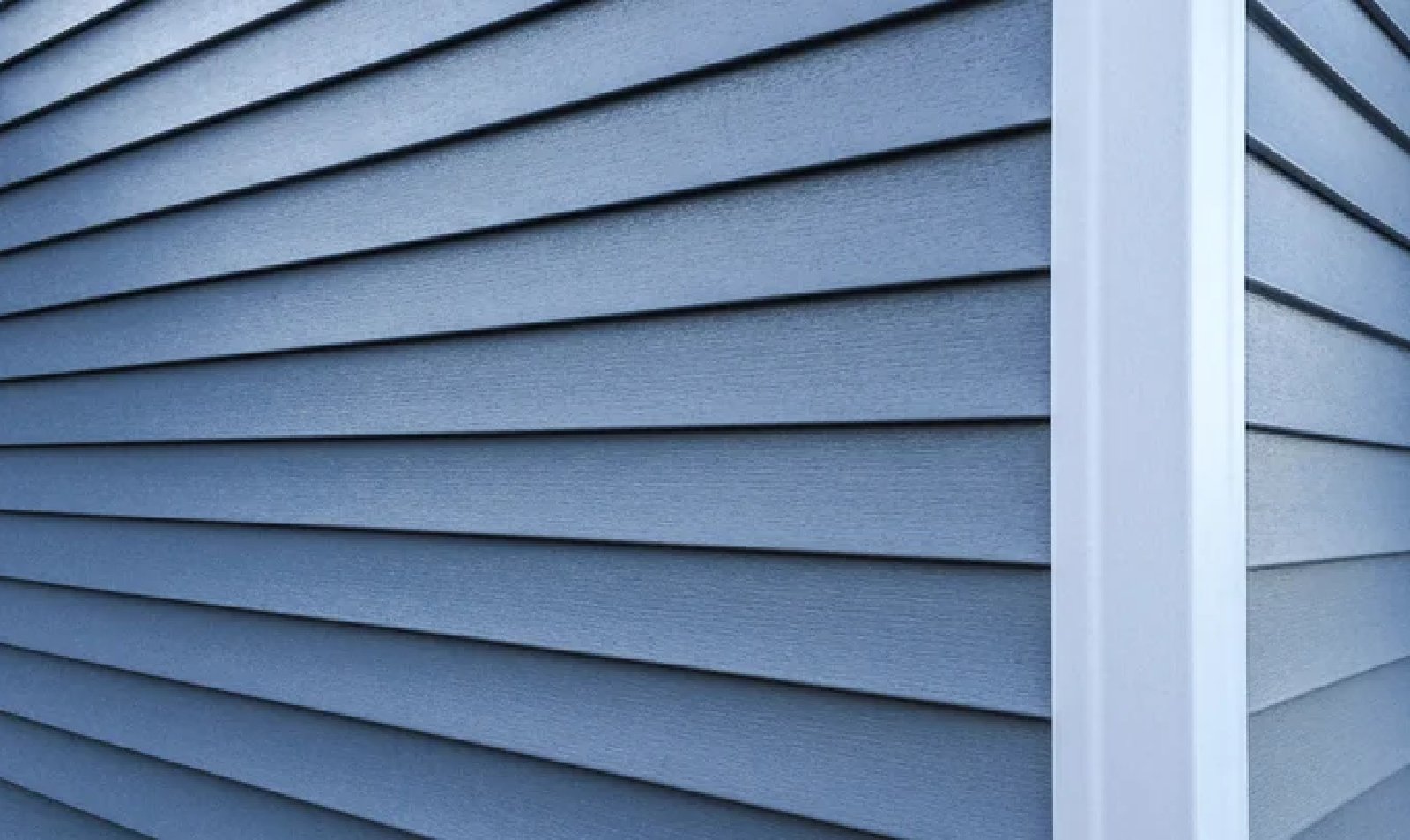 Premium vinyl siding installation showcasing a blue textured finish, emphasizing durability and low maintenance for NEPA homes.
