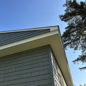 Roofline and siding of a home in Wilkes-Barre, showcasing premium Variform siding and a clear blue sky above, highlighting E-Stern Construction's home improvement services.
